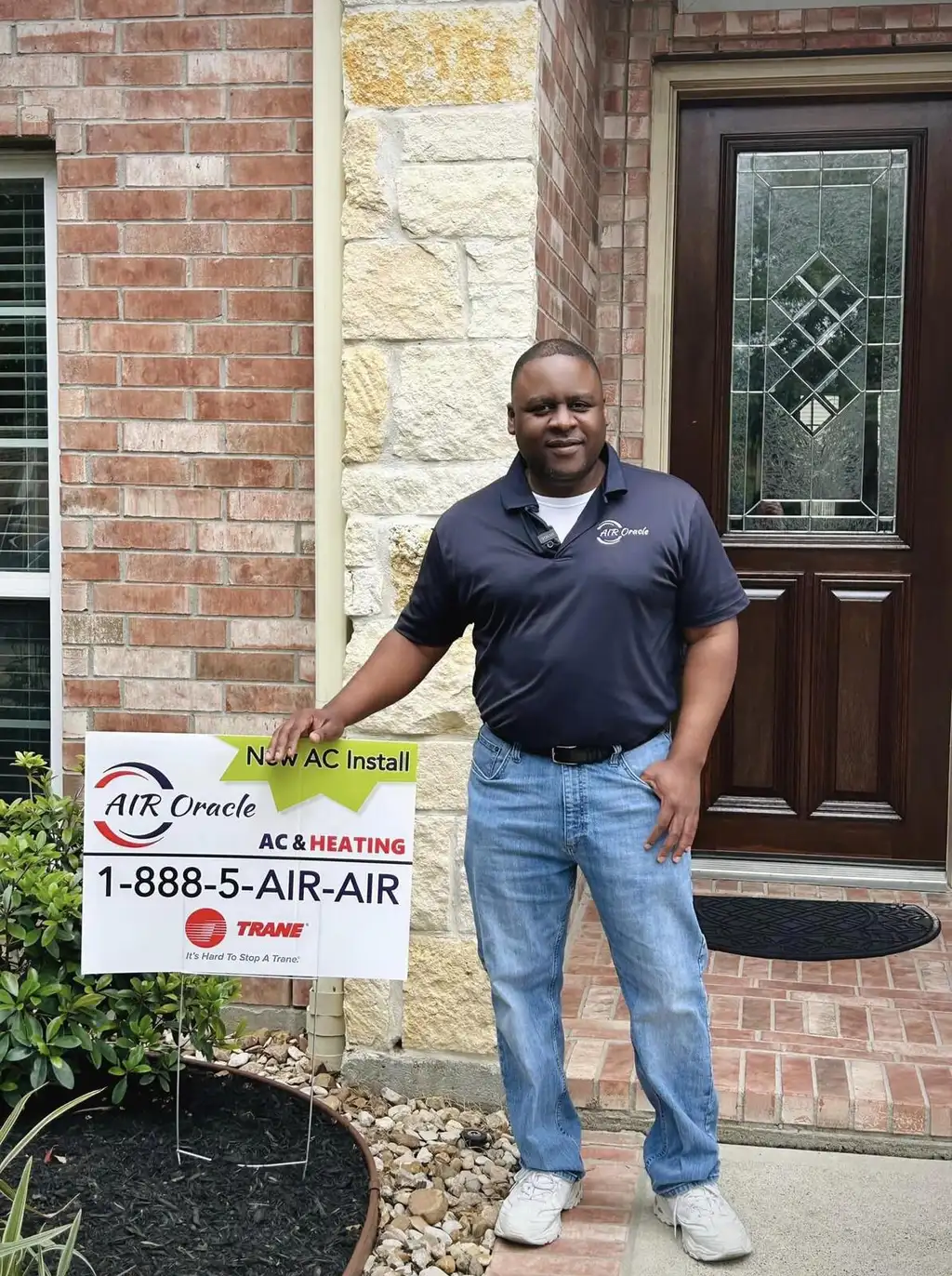 Owner James Garner beside an Air Oracle New AC Install yard sign at a job in Cypress