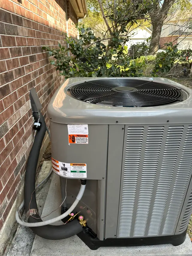Rheem condenser on its pad with a new insulated line set